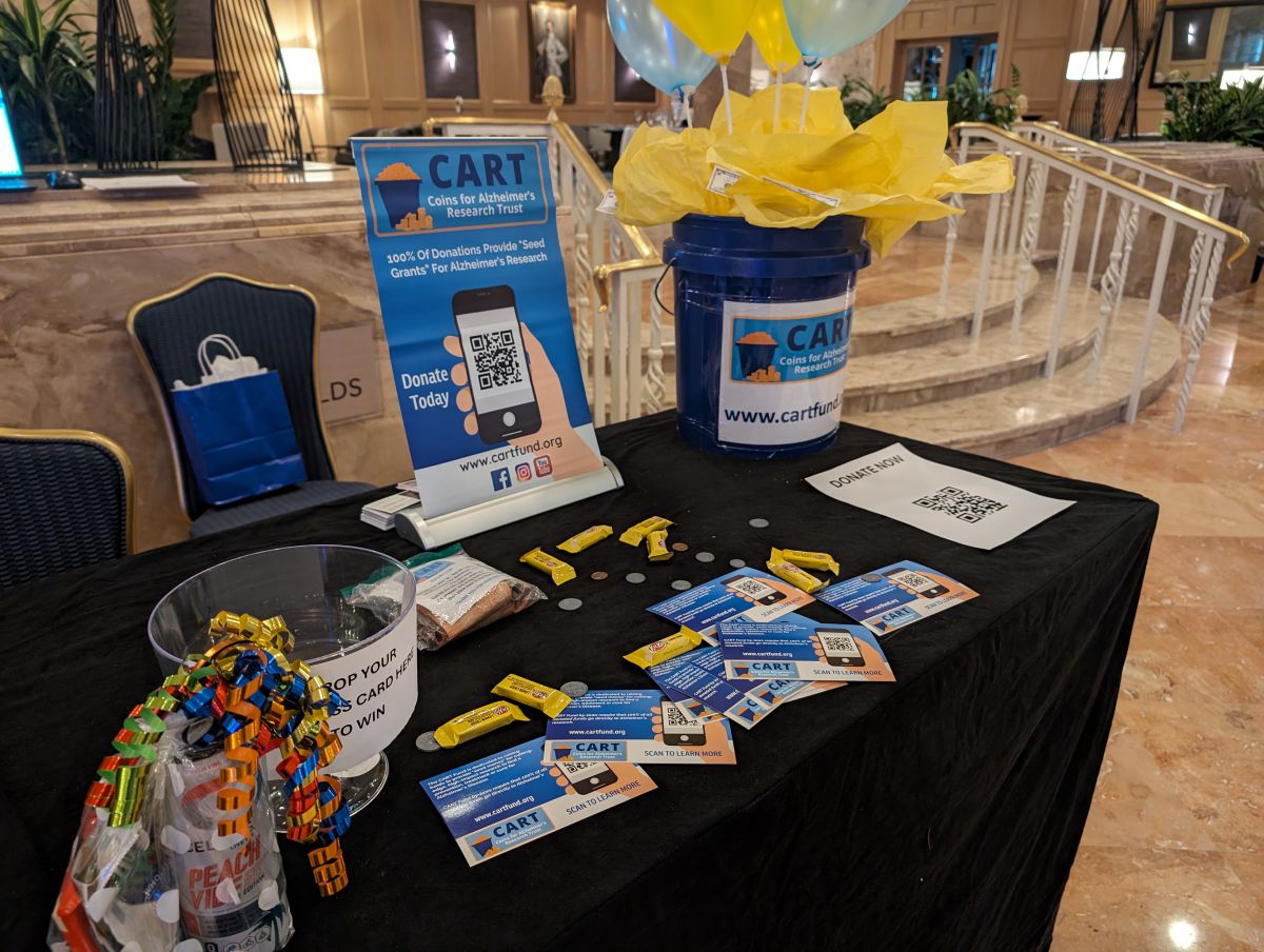 A CART Fund community fundraising display with its blue collection bucket and educational materials